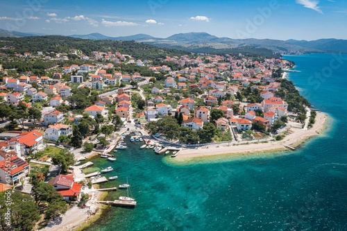Aerial view of an idyllic coastal scene featuring a tranquil blue ocean and bright white buildings photo