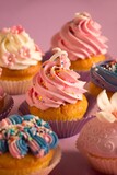 Variety of colorful cupcakes with various types of frosting