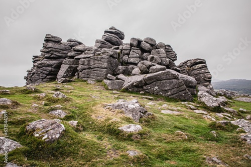 Landscape of the Haytor Rocks Dartmoor under a cloudy sky in Haytor Vale, England photo