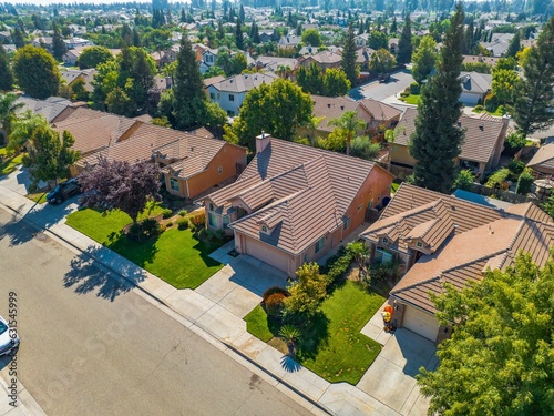 aerial view of a suburban residential area with a paved street