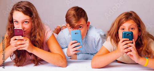 Technology and global communication concept. Portrait of phone addiction young people. Teenagers texting and and typing on the smart phones. Horizontal image.