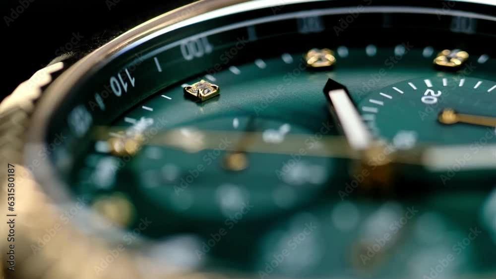 Close Up Of Stylish Luxury Man Wrist Watch With Moving Hand And Multiple Dials. Men's chronograph watch in metal with sapphire crystal. closeup view of rotating watch, running second arrow. green dial