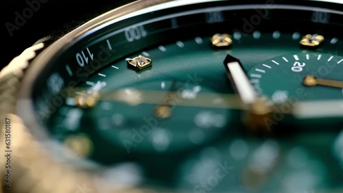Close Up Of Stylish Luxury Man Wrist Watch With Moving Hand And Multiple Dials. Men's chronograph watch in metal with sapphire crystal. closeup view of rotating watch, running second arrow. green dial