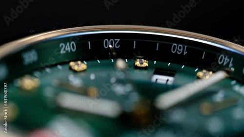 Close Up Of Stylish Luxury Man Wrist Watch With Moving Hand And Multiple Dials. Men's chronograph watch in metal with sapphire crystal. closeup view of rotating watch, running second arrow. green dial