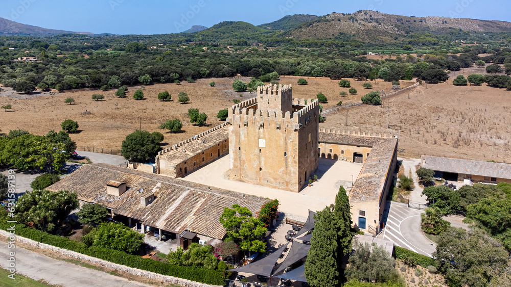 Aerial view of the Torre de Canyamel (Canyamel Tower), a square-based medieval watch tower surrounded by fortified walls in the countryside of Majorca in the Balearic Islands, Spain
