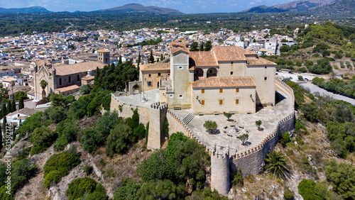 Aerial view of the pilgrimage church of Sant Salvador surrounded by fortification walls on a hill overlooking the town of Artà on Majorca in the Balearic Islands, Spain photo