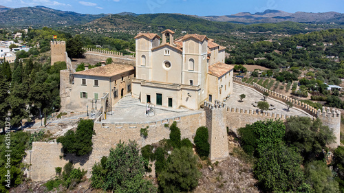 Aerial view of the pilgrimage church of Sant Salvador surrounded by fortification walls on a hill overlooking the town of Artà on Majorca in the Balearic Islands, Spain photo