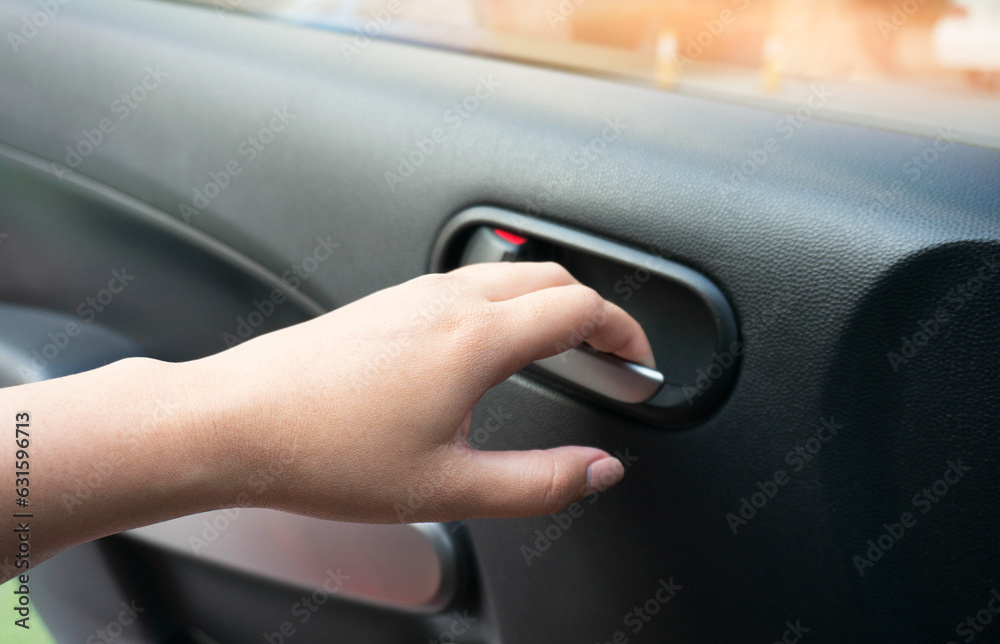 Close up of human female hand opening car door.