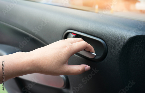 Close up of human female hand opening car door.
