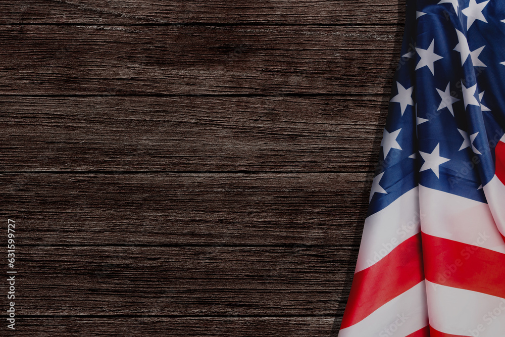 Obraz premium Stars and stripes American flag on rustic wooden background, copy space. The pride of the American people. Symbol of independence, freedom and patriotism in the USA.
