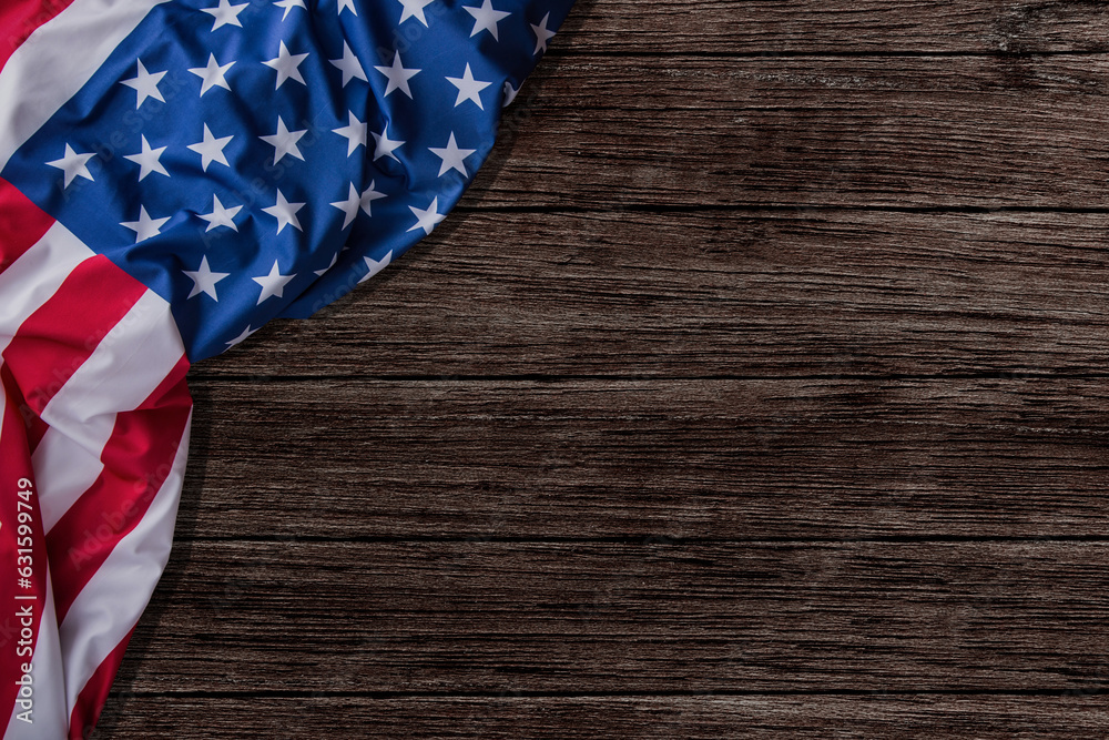 Obraz premium Stars and stripes American flag on rustic wooden background, copy space. The pride of the American people. Symbol of independence, freedom and patriotism in the USA.