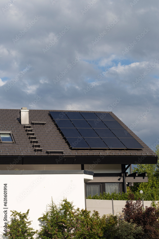 Fototapeta premium new building with solar panel and chimney on rooftop