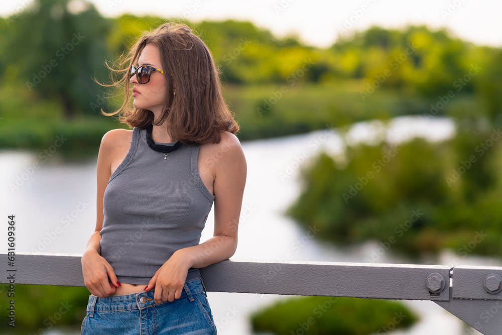 Girl looks away while standing on the bridge
