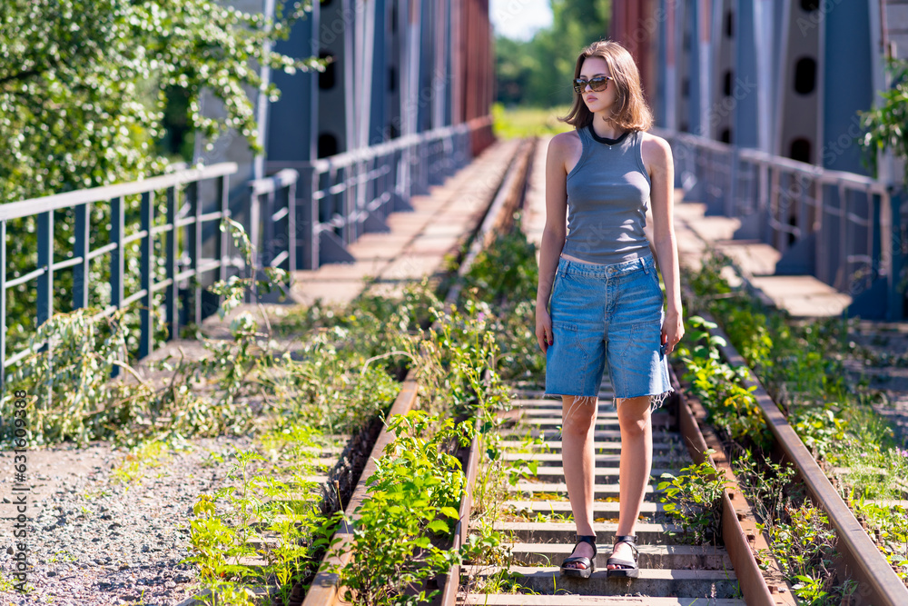 Full-length portrait of a girl on the bridge