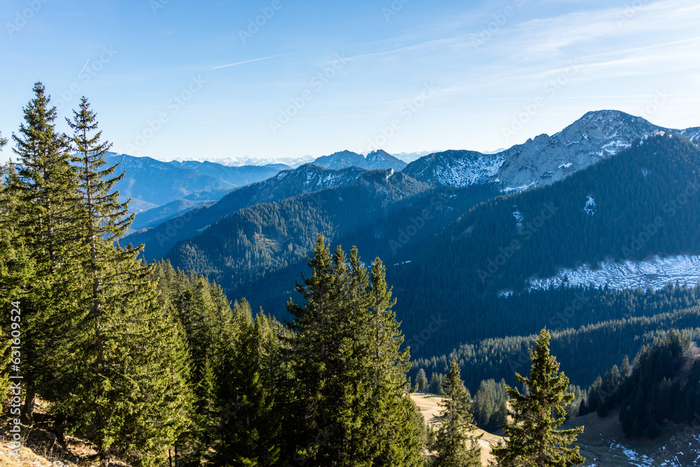 Patches of winter snow on high forested mountains