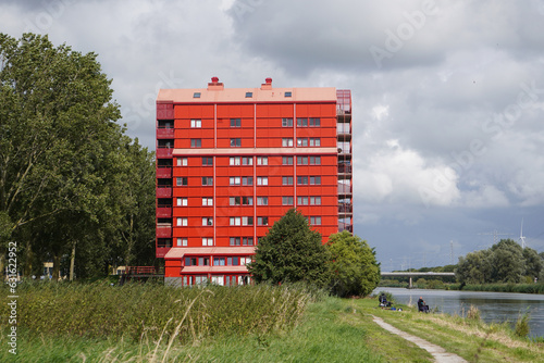 Red devil apartment Almere, architecture 'red thunders' flat, Flevopolder building, Netherlands from front perspective, horizontal photo, residential colorful photography photo