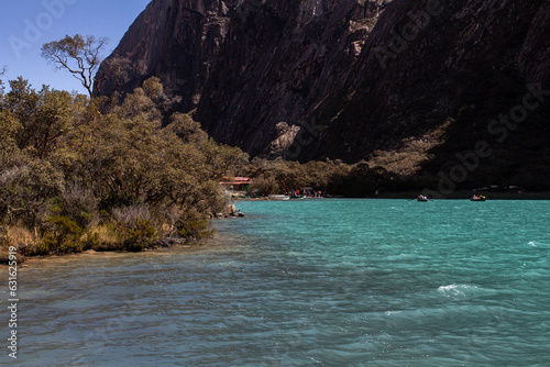 Laguna de Llanganuco desde otra vista en Los Andes de Perú, en el Parque Nacional Huascarán, cerca de Yungay. una laguna celeste rodeada de cerros y montañas photo