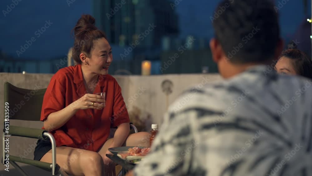 Group of Diversity Asian people friends enjoy and fun celebration meeting dinner party eating barbecue grill and drinking Korean vodka together at outdoor rooftop on summer holiday vacation at night. Group of Diversity Asian people friends enjoy and fun celebration meeting dinner party eating barbecue grill and drinking Korean vodka together at outdoor rooftop on summer holiday vacation at night.