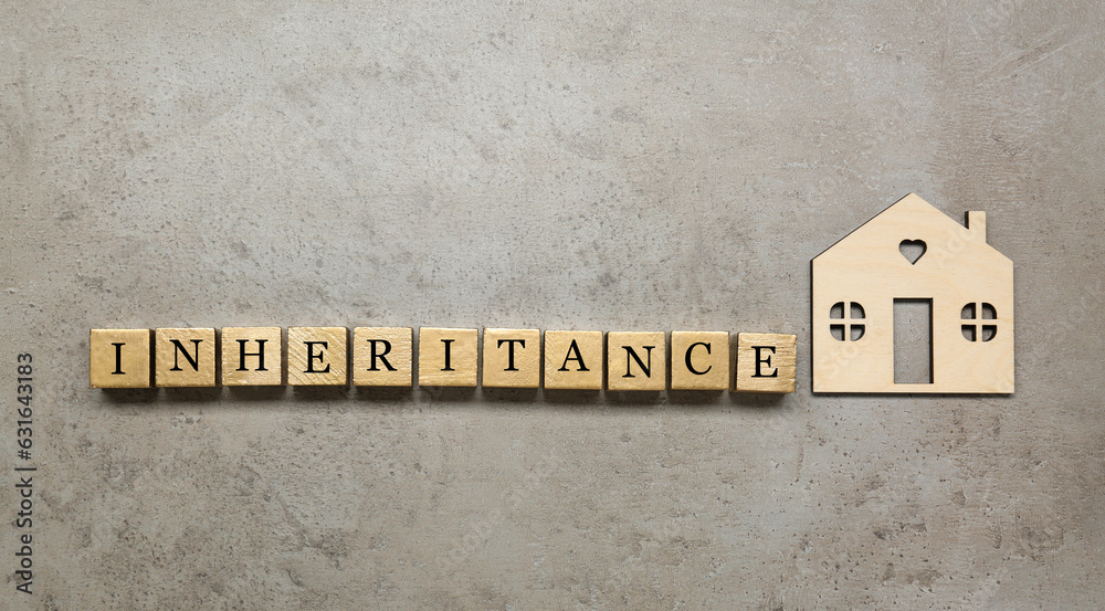 Word Inheritance made with wooden cubes and house model on grey background, flat lay Word Inheritance made with wooden cubes and house model on grey background, flat lay