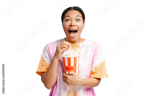 Overjoyed African American woman holding bucket with popcorn  eating snacks watching movie isolated on transparent background  clipping path. Cinema  advertisement concept