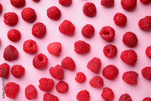 Tasty ripe raspberries on pink background, flat lay