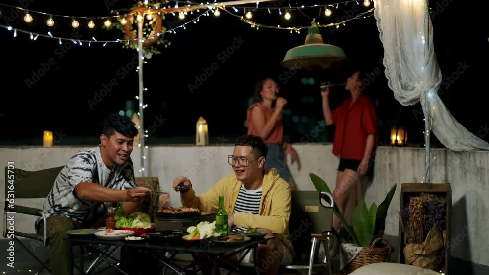 4K Group of Diversity Asian people friends enjoy and fun celebration meeting dinner party eating barbecue grill and drinking alcohol together at outdoor rooftop on summer holiday vacation at night. 4K Group of Diversity Asian people friends enjoy and fun celebration meeting dinner party eating barbecue grill and drinking alcohol together at outdoor rooftop on summer holiday vacation at night.