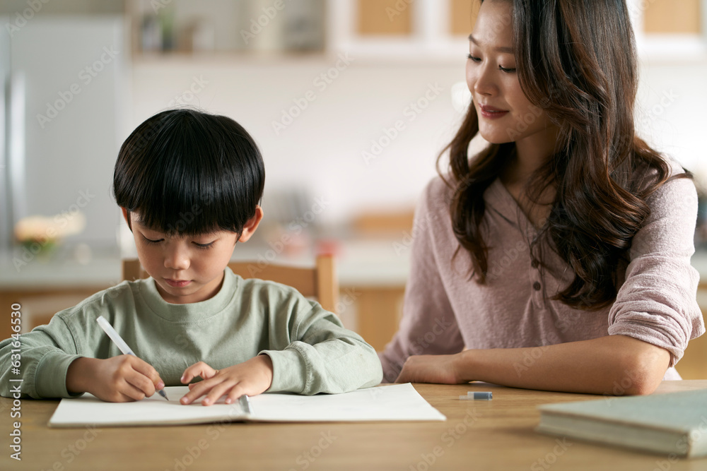 young asian mother helping son with homework young asian mother helping son with homework