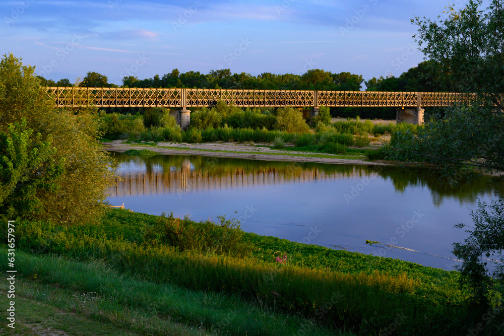 Fototapeta premium View on Pont de Pouilly-sur-Loire bridge 496 km from the source and 496 km from the mouth of the Loire river near Pouilly-sur-loire, Central France ar sunset