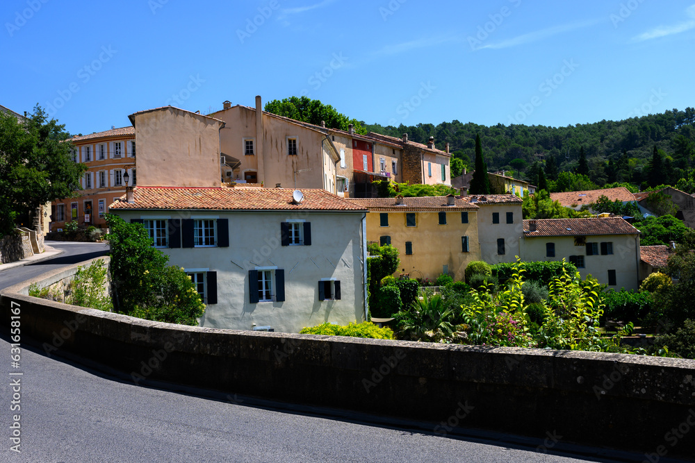 Obraz premium Travel destination, small ancient village Cotignac in Var, Provence, surrounded by vineyards and cliffs with troglodytes houses.