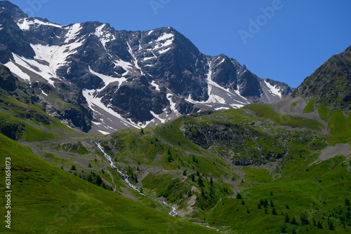 Mountains and alpine meadows views near Col du Lautaret, Massif des Ecrins, Hautes Alpes, France in summer © barmalini