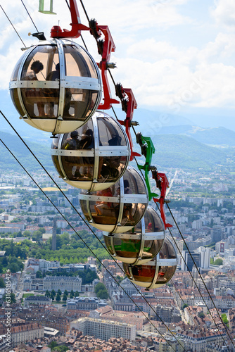 View on central part of Grenoble city from Bastille fortres witn mountains around, old cable car, Isere, France photo