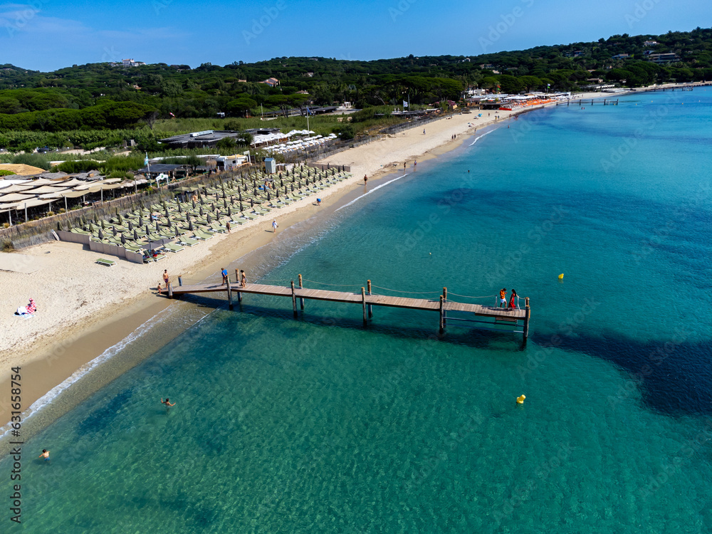 Fototapeta premium Crystal clear blue water of legendary Pampelonne beach near Saint-Tropez, summer vacation on white sandy beach of French Riviera, France
