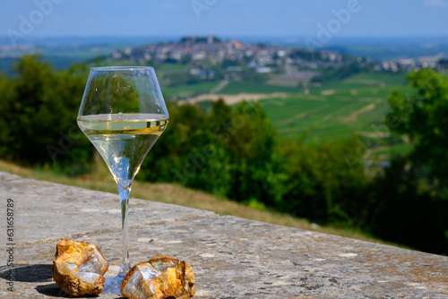Glasses white wine from vineyards of Sancerre Chavignol appelation and example of flint pebbles soil, near Sancerre village, Cher, Loire valley, France