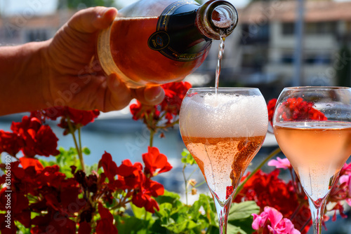 Summer party, drinking of French brut rose champagne sparkling wine in glasses in yacht harbour of Port Grimaud near Saint-Tropez, French Riviera vacation, France