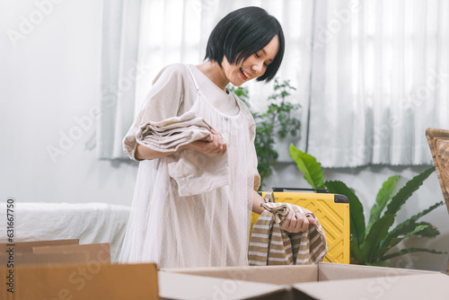 Quadro em tela Woman unpack carton box in bedroom moving house to new home or apartment