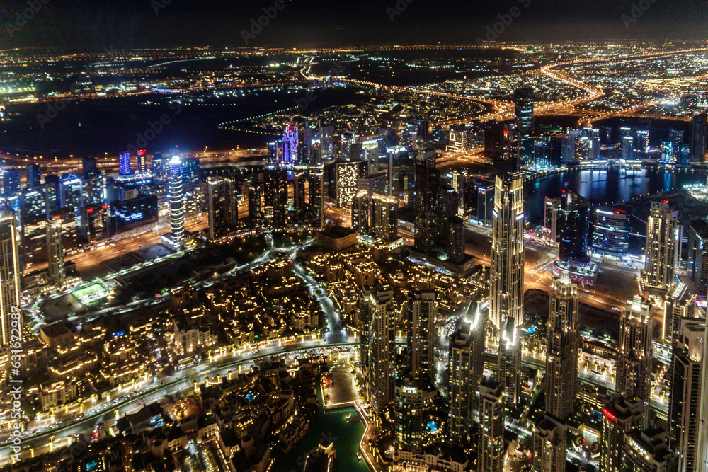 Night view from the observation deck of the tallest building in the world - Burj Khalifa illuminated by lights the Dubai city, United Arab Emirates
