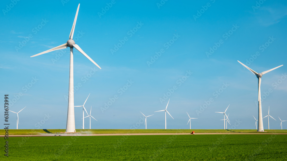 offshore windmill park with clouds and a blue sky, windmill park in the ocean aerial view with wind turbine Flevoland Netherlands Ijsselmeer. Green energy offshore windmill park with clouds and a blue sky, windmill park in the ocean aerial view with wind turbine Flevoland Netherlands Ijsselmeer. Green energy