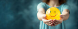 Woman hand holding happy smile sphere, Positive thinking, Mental health assessment , World mental health day concept
