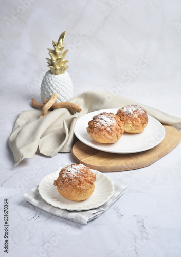 freshly handmade custard, chocolate, durian, matcha, cream puff w icing sugar cake pastry on marble luxury background with wood bamboo decoration halal food dessert menu for cafe photo