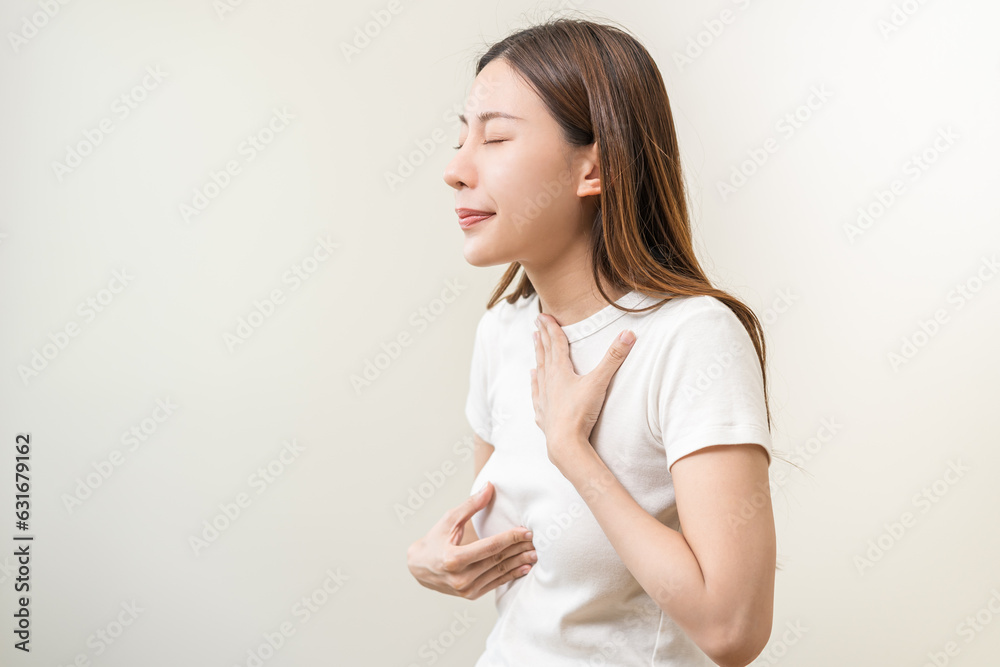 Acid reflux disease, suffer asian young woman have symptom gastroesophageal, esophageal, stomach ache and heartburn pain hand on chest from digestion problem after eat food, Healthcare medical concept Acid reflux disease, suffer asian young woman have symptom gastroesophageal, esophageal, stomach ache and heartburn pain hand on chest from digestion problem after eat food, Healthcare medical concept