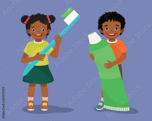 African kids holding big toothbrush and toothpaste