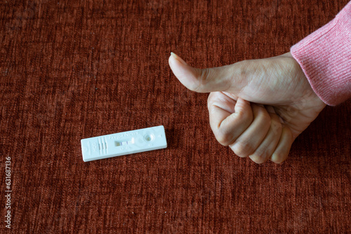 Pregnancy test kit showing positive results with thumbs up. Fertility, conception, pregnant, missed periods, baby, womb, mother, gynaecologist, obstetrician, sonography