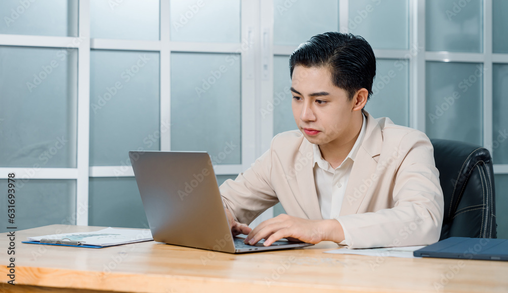 Businessman in a light blazer smiles and celebrates in front of his laptop, conveying excitement and success in a professional setting. Businessman in a light blazer smiles and celebrates in front of his laptop, conveying excitement and success in a professional setting.