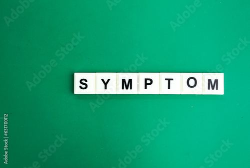 stethoscope and letters of the alphabet with the word Symptom. medical and health concepts