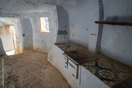 Interior of Arguedas caves with kitchen and white walls, in Spain