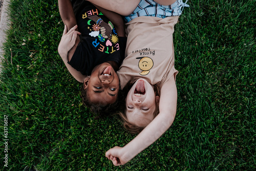 Two girls making goofy faces in grass