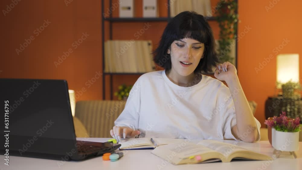 The Female student who finishes the homework is happy and peaceful. The Female student who finishes the homework is happy and peaceful.