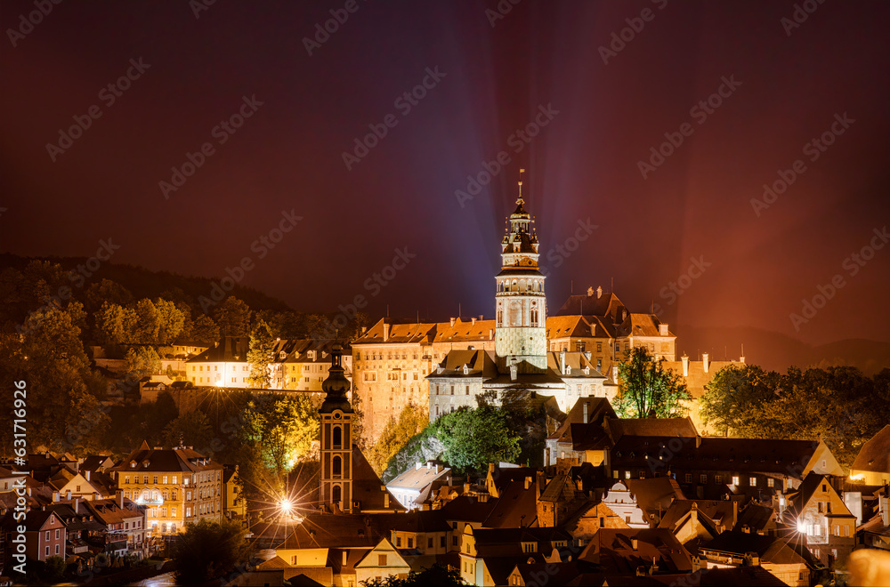 Fototapeta premium Night Shot of Beautiful Cesky Krumlov in the Czech Republic, with the Tower of St Jost Church and the Castle Dominating the City