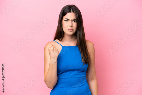 Young Brazilian woman isolated on pink background with unhappy expression