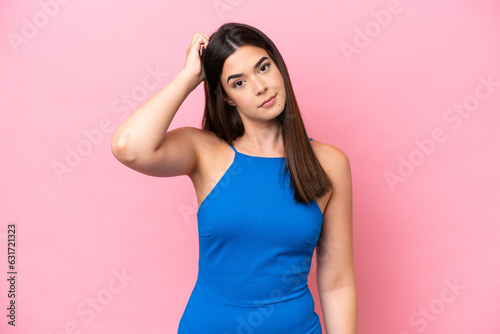 Young Brazilian woman isolated on pink background with an expression of frustration and not understanding © luismolinero
